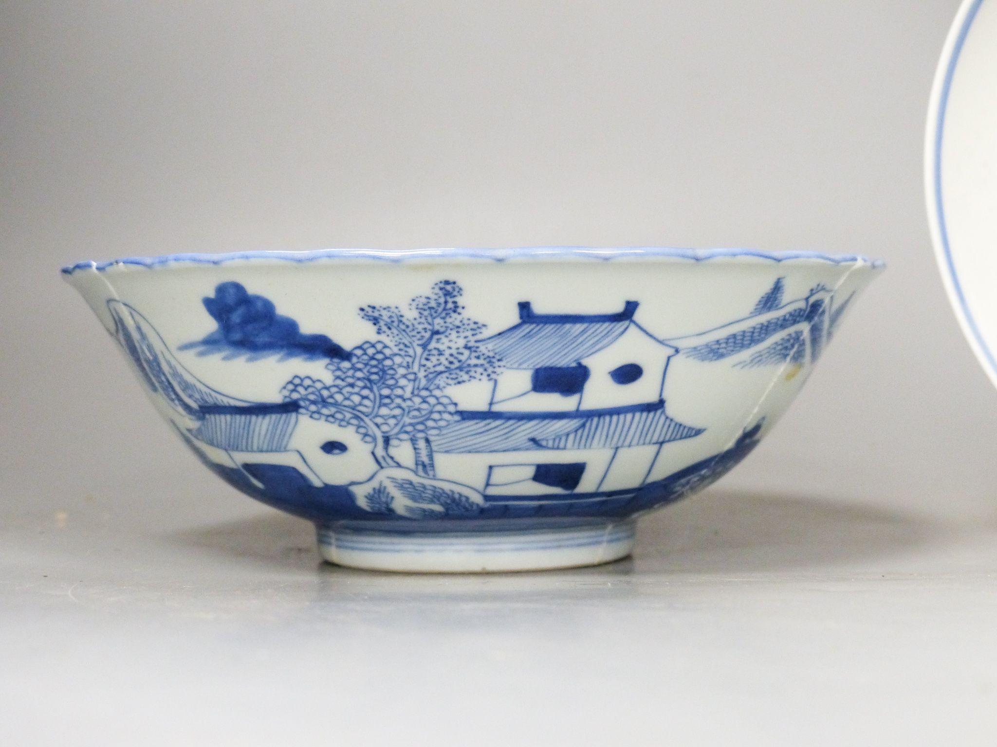 A Chinese blue and white landscape bowl, a/f and a Chinese blue and white ‘dragon’ dish, 18 and 16.5 cm